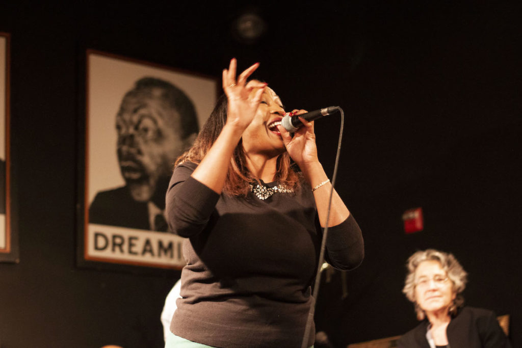 Dior Ashley Brown performs a piece at Busboys and Poets New House Celebration event.