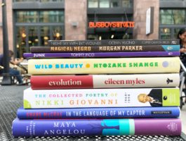 Book stack of reads for National Poetry Month at Busboys and Poets