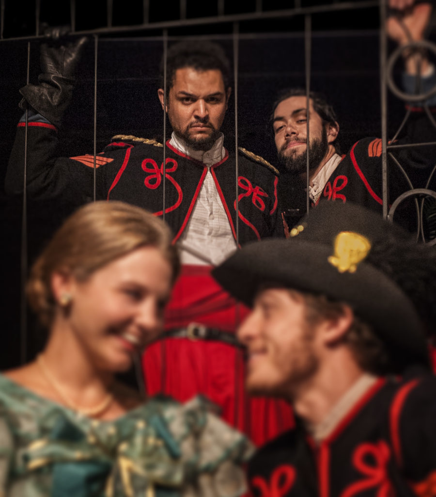 Iago (Matt Bowdren, top right) plots against Othello (Chris Okawa) & his love as he plants the idea that Desdemona (Kierna Conner) is having an affair with Cassio (Ethan Kirschbaum) in Shakespeare’s OTHELLO, running March 8 – April 5, 2015 at UA Arizona Repertory Theatre in the Tornabene Theatre (Photo by Ed Flores).