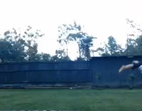 Two girls carry each other as they continue to do backflips together