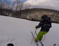 guy skiing hits other guy and falls down in snow