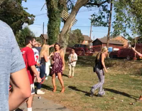 guy walks up to other guy and hits him with piece of wall 