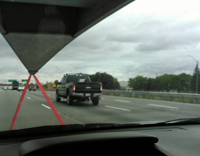 Guy records man on a highway riding motorcycle with dog on the back 