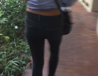 girl in blue pushes girl in black into bushes 