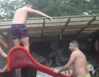 MUSIC shirtless guy sliding down wet slide 
