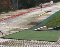 Guy slides down man made ski ramp lands on red blob