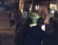 guy jumping on friends and they all fall