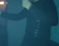 MUSIC guy black shirt dancing with orange item in mouth