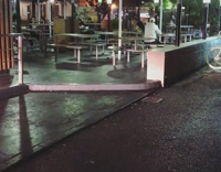 German shepherd sits on a table outside of a restaurant 