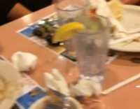 tomato thrown at man asleep on orange chairs