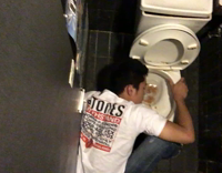 guy white shirt on ground throwing up in sink