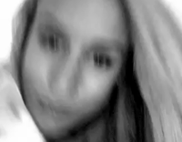 Blonde girl pets a white cat and smiles 