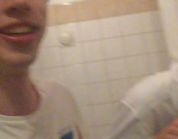 guy in white shirt throwing up in toilet