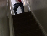 guy wearing helmet falls down staircase 