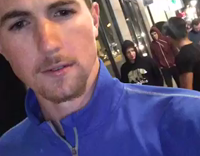 guy blue shirt holding camera and friends screaming at it