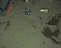 music guy looking for beer that's not empty on ground 