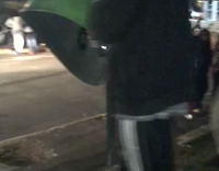 Guy in grey sweaterand khaki jeans head butts green plastic cover and falls backwards