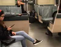 woman uses green hand weight on the subway 