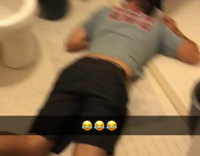 guy blue shirt asleep on ground in restroom 