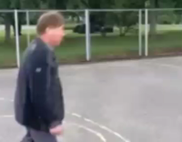 guy black shirt playing basketball falls down
