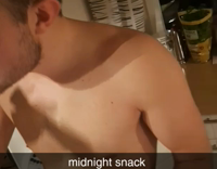 Shirtless guy takes a bite out of a gigantic leek 