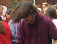 Teen in purple sweatshirt cracks beer over head and chugs it 