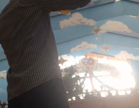 guy in gray shirt drinking beer with crowd cheering