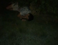 guy blue shirt laying on ground sitting up for pizza