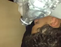 Curley hair sleeping guy gets water bottle poured on face