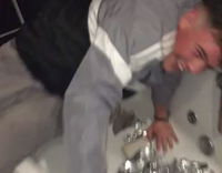 Guy reaching into bathtub full of tin foil