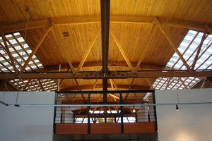 Preview of 415 Westlake - Image 0: historic, timber roof, exposed beams, skylights, industrial, structure wood, wood ceiling, trusses, modern, natural light, open space, mezzanine, black steel, interior architecture, ceiling design, structural design, contemporary, architectural details, minimalist.