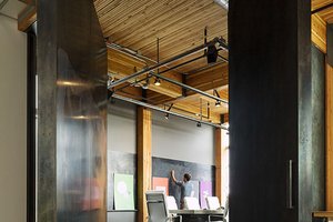 Preview of Intentional Futures - Image 0: Building, Housing, Indoors, Loft, Interior Design, Office, structrure wood, wood ceiling, exposed duct, concrete floor, steel pivot door, meeting space, heavy timber.