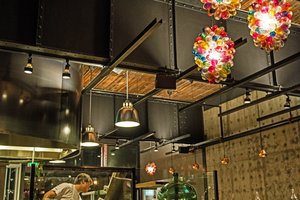 Preview of Mamnoon Restaurant - Image 3: Person, Food, Cafe, Building, Steel, Stainless Steel, Structure Steel, Exposed Structure, Wood, Exposed Duct, Concrete, Table, Dining Table, Dining, Kitchen, Glass, Window, Restaurant.