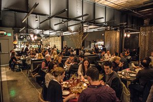 Preview of Mamnoon Restaurant - Image 4: People, Audience, Restaurant, Steel, Stainless Steel, Structure Steel, Exposed Structure, Concrete, Table, Dining, Dining Table, Sliding Partition, Glass, Kitchen, Wood, Wood Screen.
