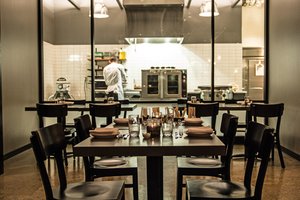 Preview of Mamnoon Restaurant - Image 6: Dining Table, Dining Room, Kitchen, Steel, Exposed Structure, Structure Steel, Appliances, Glass, Window, Restaurant.