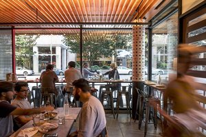 Preview of Mamnoon Street - Image 9: People, Cafe, Chair, Slide, Steel, Wood, Window, Glass, Dining Table, Restaurant, Storefront, Concrete.