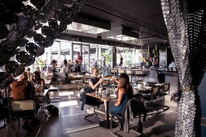 Preview of Mbar - Image 13: Human, Cafe, Chair, Furniture, Restaurant, Steel, Concrete, Glass, Window, Dining Table, Bar, Wood, Curtain, Daylight.