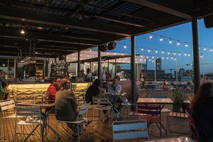 Preview of Mbar - Image 8: Human, Person, Wood, Steel, Structure Steel, Pergola, Outdoor, Rooftop, Bar, Dining Table, Window, Glass, Concrete.