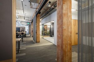 Preview of Undead Labs - Image 0: open floor plan, industrial aesthetic, exposed ceiling, mixed materials, wood beams, column, metal mesh partition, office space, carpet flooring, interior lighting, glass walls, conduit on ceiling, structure wood.