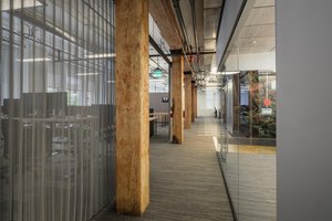 Preview of Undead Labs - Image 1: open floor plan, wood beam, concrete floor, glass partition, metal mesh, natural light, textured glass, transparent office, structure wood, carpet flooring, modern interior, indoor lighting, corridor.