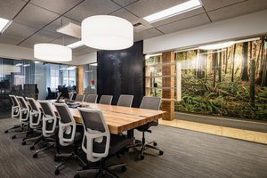Preview of Undead Labs - Image 12: modern, office, conference, wood table, pendant lighting, glass wall, open space, wood shelving, carpet flooring, nature mural, recessed lighting, office chairs, large windows, interior design.