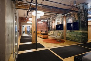 Preview of Undead Labs - Image 19: open floor plan, office space, glass partition, exposed brick, track lighting, pendant lights, color, modern furniture, wood ceiling beams, polished concrete floor, structure wood, commercial design, interior branding, corridor.