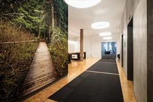 Preview of Undead Labs - Image 5: concrete wall, wood flooring, pendant lighting, corridor, glass wall, nature imagery, modern, open space, minimalist, interior design, contemporary, railing.