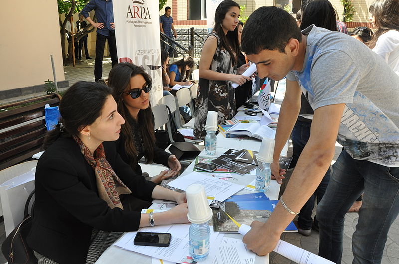 people at an outdoor information fair