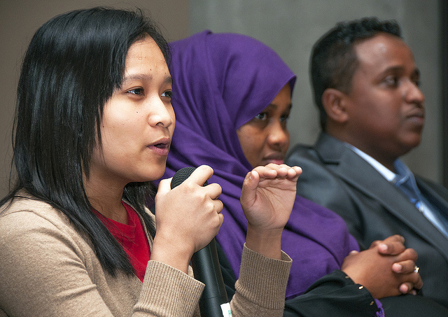 three people speaking on a panel