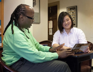 A male college counselor meets with a female student