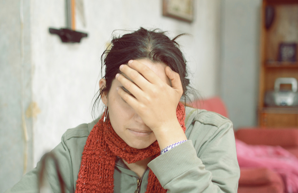 a woman with a hand over her face