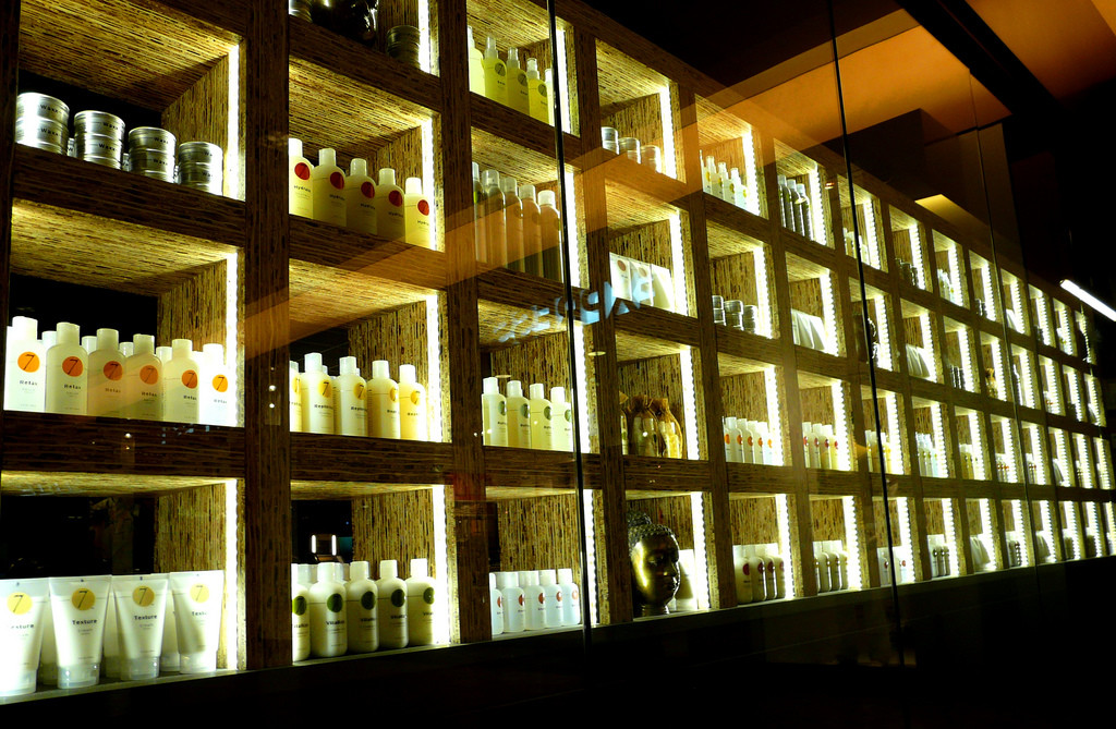 Photo of rows of salon shelves full of hair-care products.