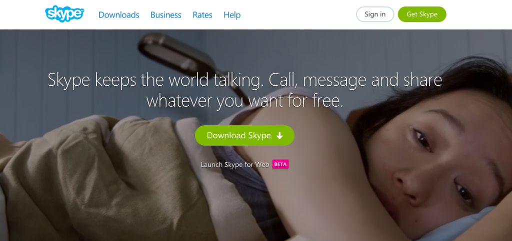 A screenshot of Skype's website. Over a large photo of a sad woman laying down are the words "Skype keeps the world talking. Call, message, and share whatever you want for free." Below that text is a green button that says "Download Skype".