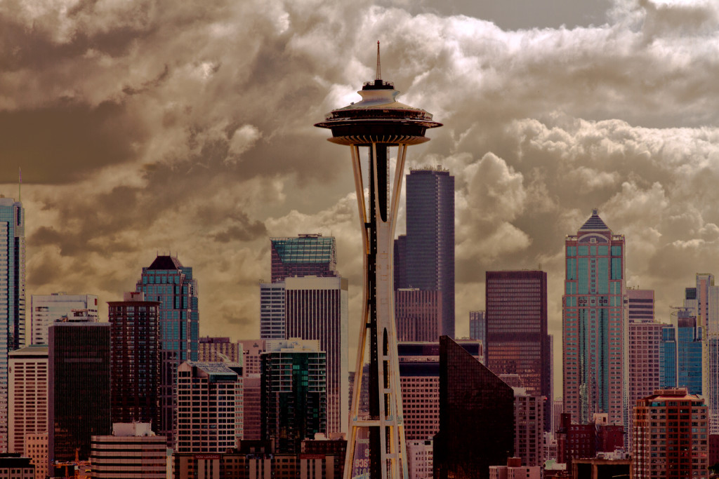 A view of the Seattle, Washington, skyline at dusk. The Seattle Space Needle is in the foreground.